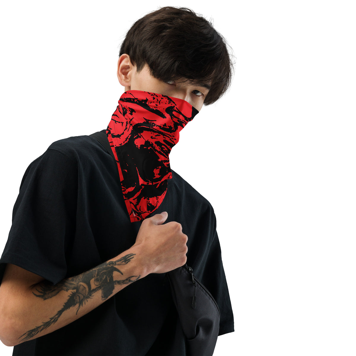 A person wearing a red and black abstract patterned neck gaiter/balaclava over their mouth and nose, paired with a black t-shirt, shown against a solid white background.